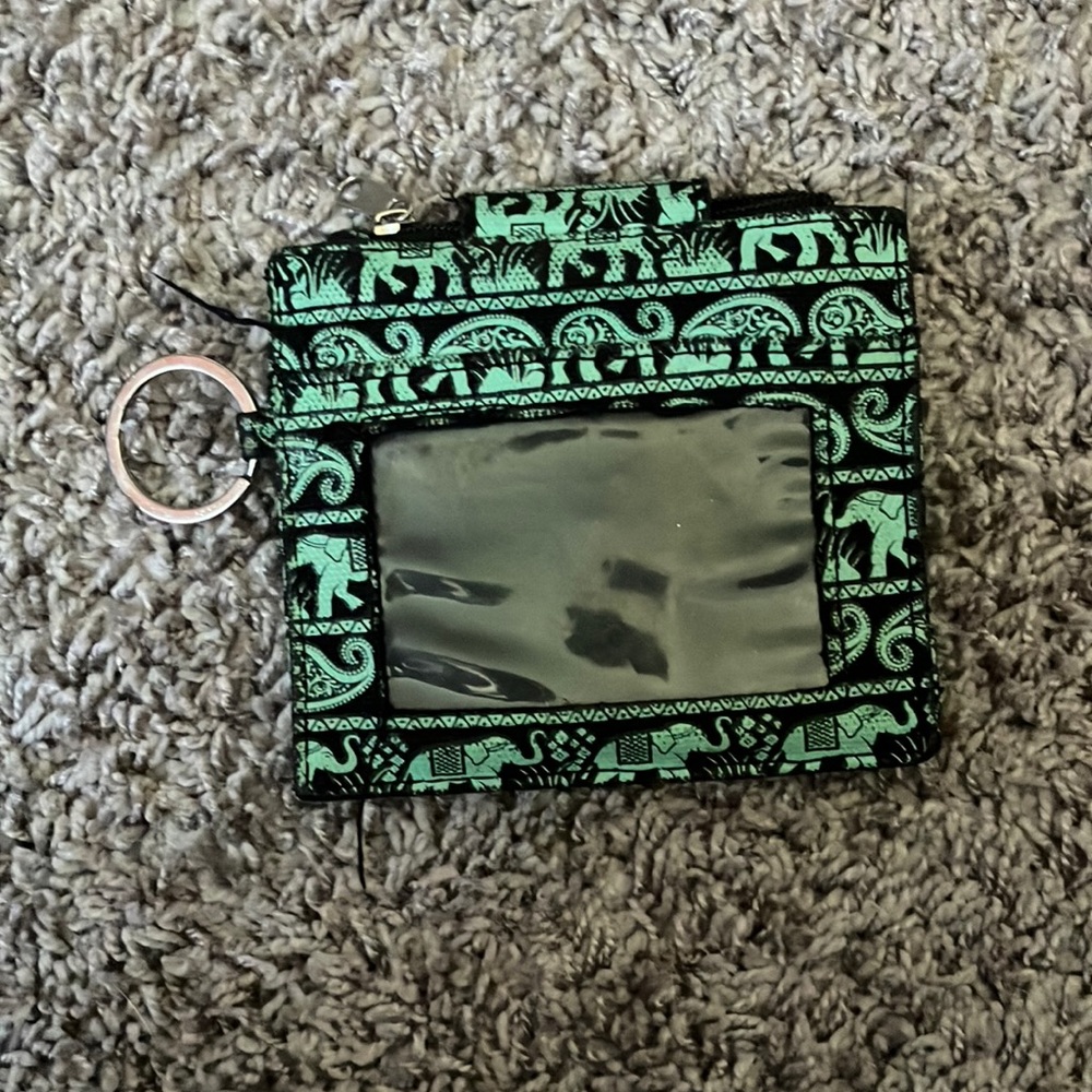 ID holder. Can attach to end of lanyard. Elephant print. Greenish color